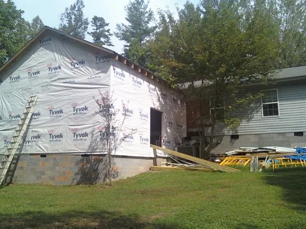 Tyvek wrapped gable on a new room addition beside an existing home in Crookston